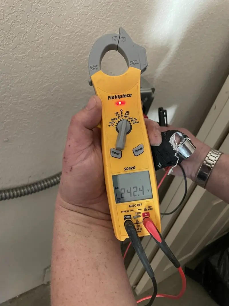 Voltage testing with clamp meter during Whole House Surge Protector in St. Joseph